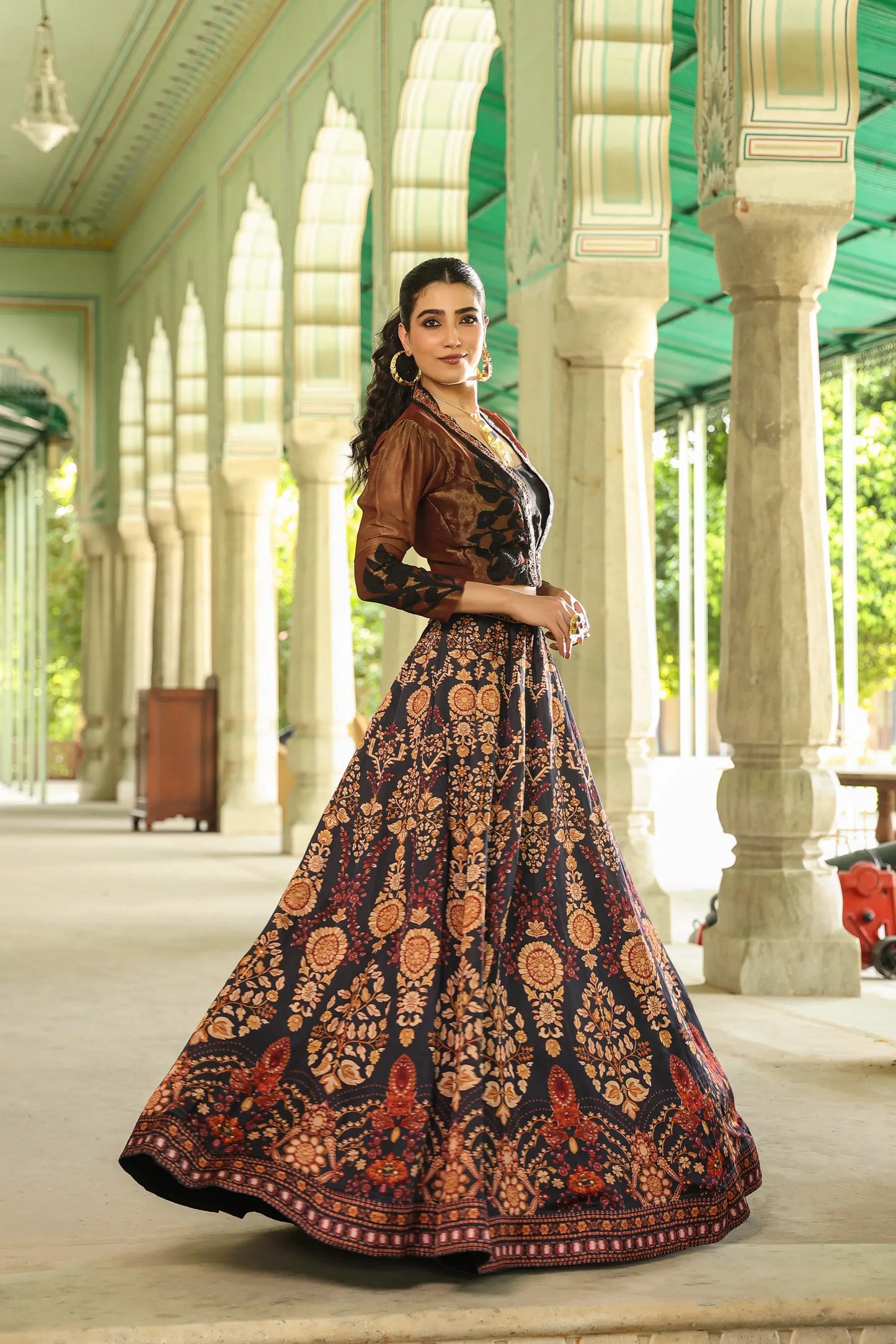 A black colour traditional print lehanga with Stylist full sleeves blouse