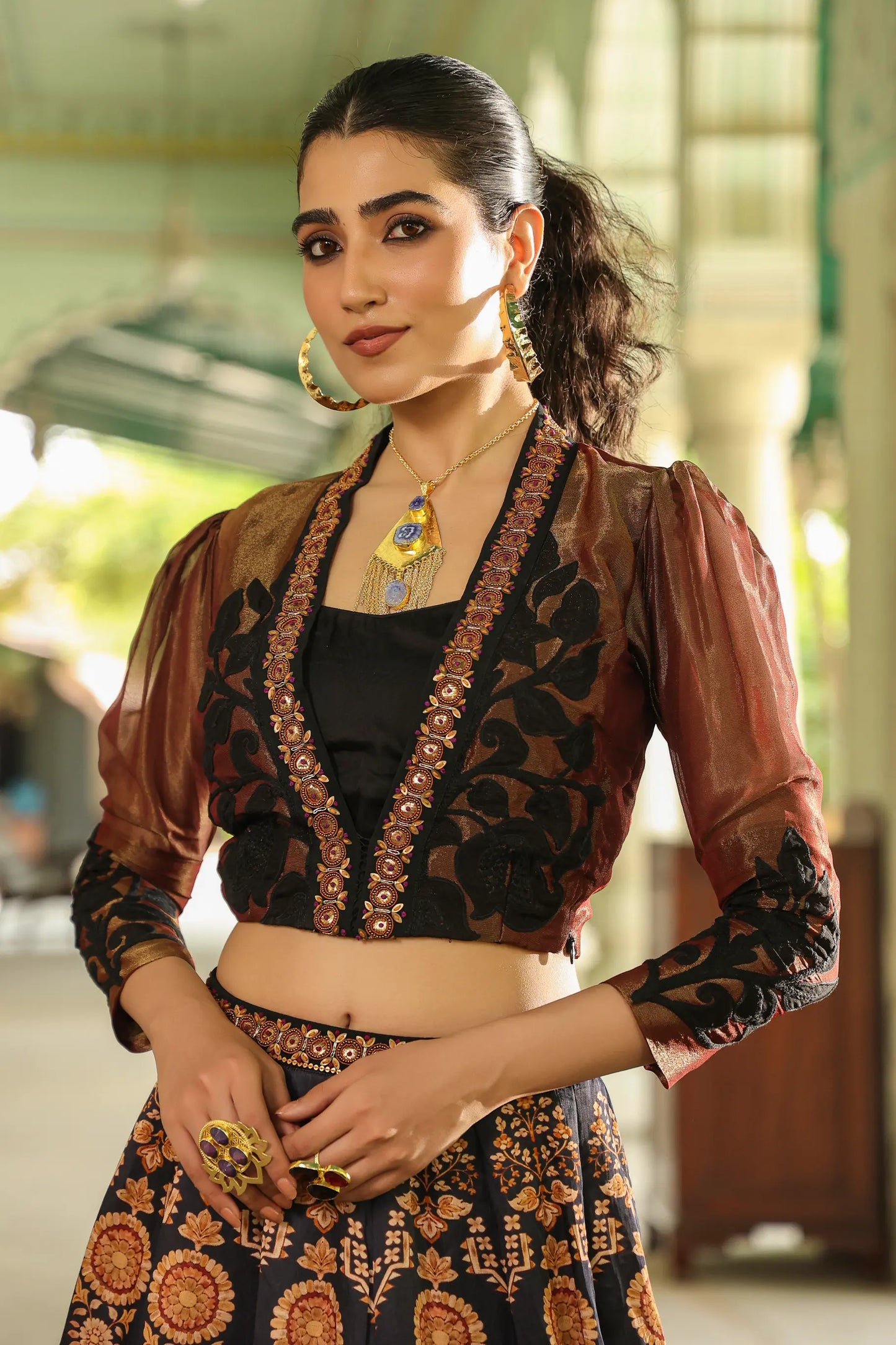 A black colour traditional print lehanga with Stylist full sleeves blouse